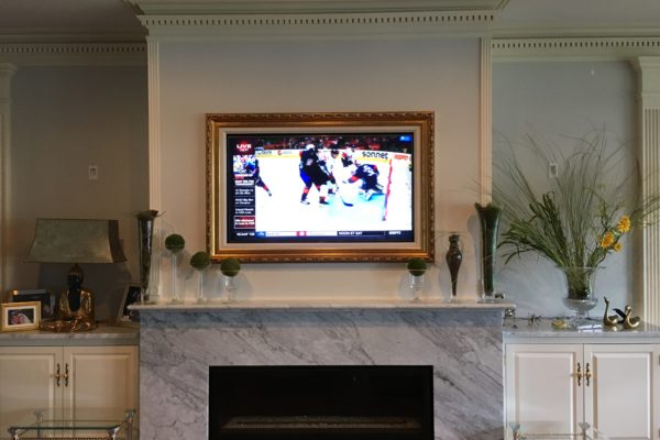 Hidden Television over fireplace exposed