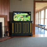 Hidden TV in a green and yellow cabinet