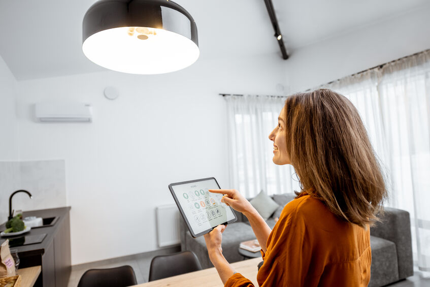 Woman Controlling Lighting with a Tablet at Home